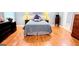 Main bedroom with hardwood floors, gray walls, tray ceiling and dresser at 1252 Heritage Dr, Villa Rica, GA 30180