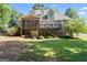 Expansive backyard view with a screened porch, deck, and lush greenery at 914 Champions Way, Mcdonough, GA 30252