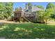 Expansive backyard view with a screened porch, deck, and lush greenery at 914 Champions Way, Mcdonough, GA 30252
