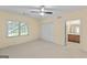 Spacious bedroom featuring plush carpets, ceiling fan, and closet space at 914 Champions Way, Mcdonough, GA 30252