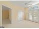 Open bedroom featuring plush carpets, ceiling fan, and french doors at 914 Champions Way, Mcdonough, GA 30252