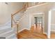 Spacious foyer features hardwood floors, a staircase, and a view into the living room at 914 Champions Way, Mcdonough, GA 30252