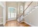 Welcoming foyer boasts hardwood floors, a staircase, and plenty of natural light at 914 Champions Way, Mcdonough, GA 30252