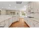 Kitchen with white cabinets, stainless steel appliances, hardwood floors, and breakfast nook at 914 Champions Way, Mcdonough, GA 30252