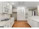 Spacious kitchen features white cabinets, stainless appliances, and hardwood flooring at 914 Champions Way, Mcdonough, GA 30252