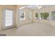 Bright Living room with many windows and a glass door at 914 Champions Way, Mcdonough, GA 30252