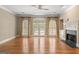 Spacious living room boasts hardwood floors, fireplace, and French doors to the backyard at 914 Champions Way, Mcdonough, GA 30252
