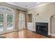 Living room with fireplace, plantation shutters and french door to the backyard at 914 Champions Way, Mcdonough, GA 30252