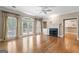 Living room with hardwood floors, fireplace, plantation shutters and access to the kitchen at 914 Champions Way, Mcdonough, GA 30252