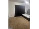 Bedroom featuring neutral carpet, ceiling fan, and a single bed with dark blackout curtains at 4619 S Seminole Dr, Douglasville, GA 30135
