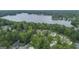 Stunning aerial view showcases lakeside homes surrounded by lush greenery and mature trees at 107 Edgewater Way, Peachtree City, GA 30269