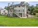 Spacious backyard view of a two-story home with a deck and lush, green grass at 107 Edgewater Way, Peachtree City, GA 30269