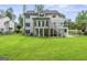 Expansive backyard with a two-story home featuring a deck and well-maintained lawn at 107 Edgewater Way, Peachtree City, GA 30269