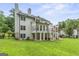 View of the home's back facade, deck, and fenced yard, showing the outdoor living space at 107 Edgewater Way, Peachtree City, GA 30269