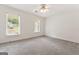 Large carpeted bedroom with two windows allowing ample natural light at 107 Edgewater Way, Peachtree City, GA 30269