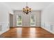 Formal dining room featuring hardwood floors, wainscoting, and windows offering natural light at 107 Edgewater Way, Peachtree City, GA 30269