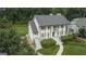 Aerial view of a stately home with mature trees and manicured landscaping at 107 Edgewater Way, Peachtree City, GA 30269