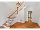 Elegant foyer with wood floors, staircase, and classic detailing exudes warmth and charm at 107 Edgewater Way, Peachtree City, GA 30269