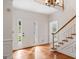 Bright foyer featuring hardwood floors, a staircase, and a view of the front yard at 107 Edgewater Way, Peachtree City, GA 30269