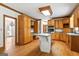 Traditional kitchen with island gas cooktop, ample wood cabinets, and hardwood floors at 107 Edgewater Way, Peachtree City, GA 30269