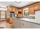Traditional kitchen with island gas cooktop, wood cabinets, hardwood floors, and modern appliances at 107 Edgewater Way, Peachtree City, GA 30269