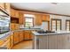 Traditional kitchen with island gas cooktop, window view, and lots of cabinet storage at 107 Edgewater Way, Peachtree City, GA 30269