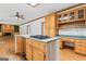View of kitchen with gas cooktop island, tile backsplash, and cabinets with great storage at 107 Edgewater Way, Peachtree City, GA 30269