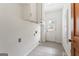 Small laundry room with white walls and cabinets and a door for exterior access at 107 Edgewater Way, Peachtree City, GA 30269