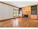 Spacious living room with hardwood floors, built-in bookshelves, fireplace and wood trim at 107 Edgewater Way, Peachtree City, GA 30269