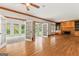 Open-concept living room features hardwood floors, built-in bookshelves, fireplace, and glass doors at 107 Edgewater Way, Peachtree City, GA 30269