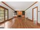 Spacious living room with hardwood floors, a cozy fireplace, and stylish built-in bookcases at 107 Edgewater Way, Peachtree City, GA 30269