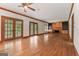 Expansive living room featuring hardwood floors, a fireplace, and built-in shelving at 107 Edgewater Way, Peachtree City, GA 30269