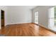 Bright, airy living room with hardwood floors and natural light flooding through windows at 107 Edgewater Way, Peachtree City, GA 30269