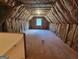 A spacious, insulated attic space with a window, ready to be transformed at 424 Ivey Edwards Ln, Mcdonough, GA 30253