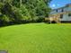 Expansive backyard with lush green lawn and a deck at 424 Ivey Edwards Ln, Mcdonough, GA 30253