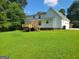 Spacious backyard featuring a wooden deck with stairs to the large lawn at 424 Ivey Edwards Ln, Mcdonough, GA 30253