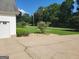 Lawn and driveway next to the garage of a house with green lawn at 424 Ivey Edwards Ln, Mcdonough, GA 30253