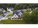 Aerial view of neighborhood with brick home featuring a manicured lawn, lush landscaping at 184 Fashion Xing, Mcdonough, GA 30252