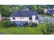 Aerial view of a two-story home with manicured backyard and a lush green lawn at 184 Fashion Xing, Mcdonough, GA 30252