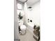 Clean bathroom offers a shower-tub combo, toilet, and shelving for organized and serene experience at 184 Fashion Xing, Mcdonough, GA 30252