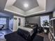 Sophisticated bedroom featuring tray ceilings, wall paneling, and modern decor at 184 Fashion Xing, Mcdonough, GA 30252