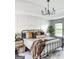 Beautiful bedroom featuring a modern chandelier, board and batten accent wall, and stylish decor at 184 Fashion Xing, Mcdonough, GA 30252
