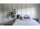 Stylishly decorated bedroom featuring wainscoting detail, throw pillows, and a modern side table at 184 Fashion Xing, Mcdonough, GA 30252