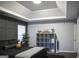 Contemporary bedroom featuring stylish wall paneling, tray ceiling, and sleek furniture at 184 Fashion Xing, Mcdonough, GA 30252