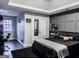 Sleek bedroom featuring dark accent walls, a tray ceiling, and modern decor at 184 Fashion Xing, Mcdonough, GA 30252