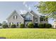 Charming brick home featuring a manicured lawn, lush landscaping, and a classic architectural design at 184 Fashion Xing, Mcdonough, GA 30252