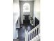 Welcoming two-story foyer with hardwood floors, a grand chandelier, and an elegant entry door at 184 Fashion Xing, Mcdonough, GA 30252