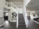 Bright foyer with wooden floors and a staircase with white railings, leading to the upper level at 184 Fashion Xing, Mcdonough, GA 30252