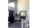 Inviting foyer with a dark front door, a modern light fixture, and stylish decor and hardwood floors at 184 Fashion Xing, Mcdonough, GA 30252