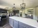 This kitchen features an oversized island with seating, custom cabinets, modern appliances, and upgraded lighting at 184 Fashion Xing, Mcdonough, GA 30252